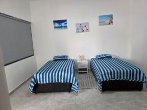 Una cama o camas en una habitación de aylana Village