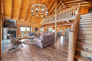 een woonkamer met een bank en een open haard bij Altitude Adjustment in Sevierville