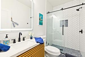 a bathroom with a tub and a toilet and a shower at High-end Waterfront Near Beach & SpaceX Views in South Padre Island +44 photos