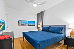 a bedroom with a blue bed and a ceiling fan at High-end Waterfront Near Beach & SpaceX Views in South Padre Island