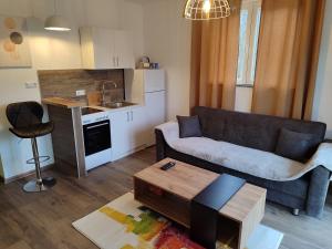a living room with a couch and a table at A&H Pliva Retreat in Jajce