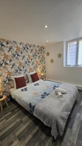 a bedroom with a large bed with a blue blanket at Le Petit Caporal - Cour Privée - Parking Privée in Bracieux