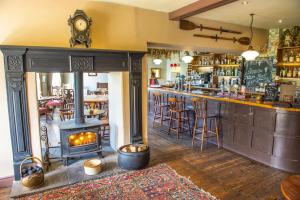 a bar with a fireplace in the middle of a room at The Cuckoo Brow Inn in Far Sawrey