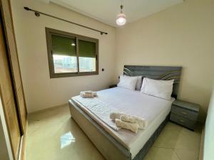 a bedroom with a large bed with two towels on it at Residence Noor - Central Apartments Fes in Fez