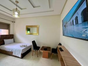 フェズにあるResidence Noor - Central Apartments Fesのベッドとテレビがあるホテルの部屋