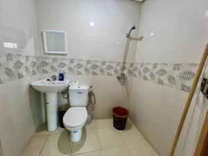 a bathroom with a toilet and a sink at Residence Noor - Central Apartments Fes in Fez +25 photos