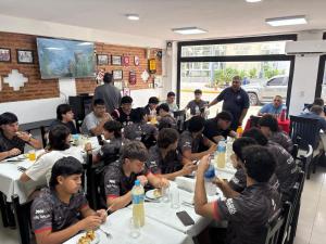 a group of people sitting at tables eating food at HOTEL REGINA Formosa in Formosa