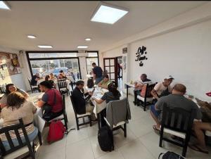 a group of people sitting at tables in a restaurant at HOTEL REGINA Formosa in Formosa