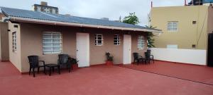 a house with chairs on a red patio at Calle 3 1526 in Santa Teresita