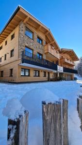 a large building with a rink in front of it at Lake View Lodge in Flachau