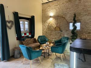 a living room with a couch and chairs and a table at Appartement de luxe "L'Écrin de l'Amour" in Saint-Avertin