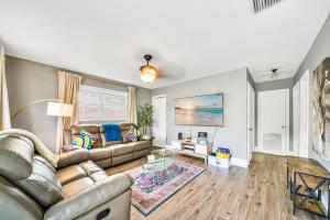 a living room with a couch and a table at Relax at Serenity Heated Pool Spa BBQ Near Beach in Palm Beach Gardens