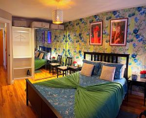 a bedroom with a large bed and a living room at Latitude Chinatown Central Apartment in Birmingham