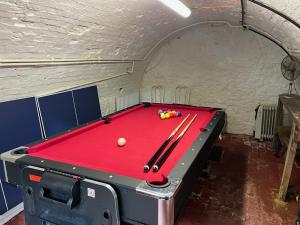 a room with a pool table in a cave at 4 St Richard’s Cottages in Fittleworth