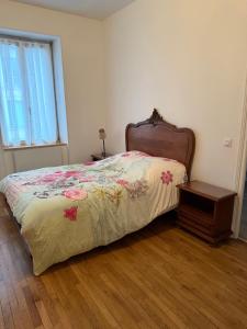 a bedroom with a bed and a table and a window at Namasté 2 in Étain