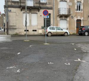 a parking lot with cars parked in front of a building at Namasté 2 in Étain