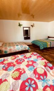 Giường trong phòng chung tại Pueblito Quindiano