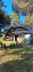 a group of benches in the grass in front of a building at Pax Costa del Este in Costa del Este +4 photos