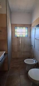a bathroom with a toilet and a tub and a sink at Pax Costa del Este in Costa del Este