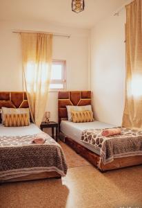 Кровать или кровати в номере Maison pres plus Grand Bazar d'Afrique Souk El Had