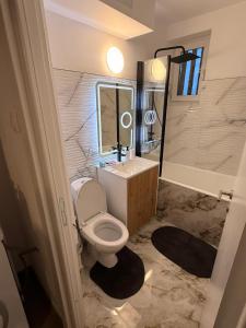 a bathroom with a toilet and a sink and a shower at Ru apartment in Craiova