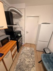 a kitchen with a stove and a white door at Ru apartment in Craiova +2 photos