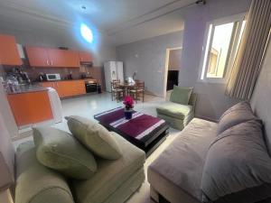 una sala de estar con un sofá y una mesa en appartement luxe, en Berkane