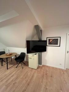 a living room with a large flat screen tv on the wall at Luxus Ferien Apartment vS in Marburg an der Lahn