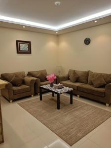 a living room with two couches and a coffee table at اختيار السائح للشقق المخدومة in Jazan +35 photos