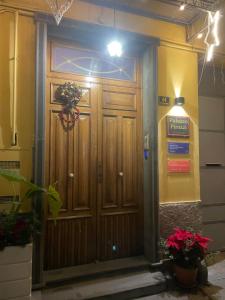 a large wooden door with a wreath on it at Pompei Duplex Apartment Deluxe in Boscoreale +167 photos