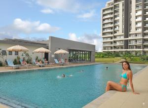 a woman in a bikini sitting in a swimming pool at Splendid Mountains View Three Bedroom Apartment in Moka