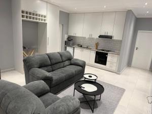 a living room with two couches and a table at 268 Self-catering Apartments in Swakopmund