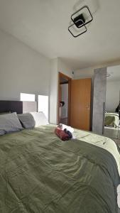 a large bed with a green comforter in a bedroom at Appartamento da Nonna Anna in Montagna in Valtellina