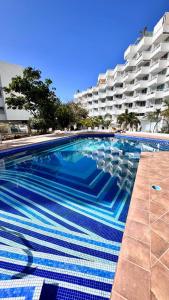 a swimming pool in front of a large building at Las Americas 200 B apartment in Costa de Adeje