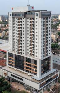 a tall white building with a lot of windows at Flat 1807 - Sunset Experience Alto Padrão in Dourados