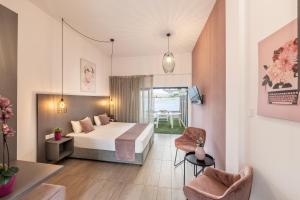 a hotel room with a bed and a table and chairs at Lantiana Gardens ApartHotel in Protaras +98 photos
