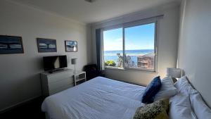 Ένα ή περισσότερα κρεβάτια σε δωμάτιο στο Pelicans Perch