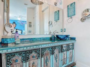 a bathroom with a sink and a mirror at Inn on the Avenue in New Smyrna Beach