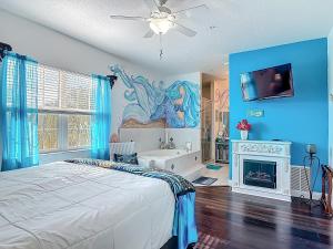 a bedroom with a bed and a painting of a mermaid at Inn on the Avenue in New Smyrna Beach