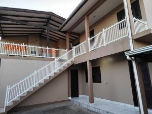 an external view of a building with stairs at Apto com terraço coberto in Arroio do Sal
