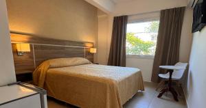 a hotel room with a bed and a window at Encanto Del Mar in Ostende