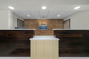 a lobby with a sign on a brick wall at City Express by Marriott Yulee in Yulee +16 photos