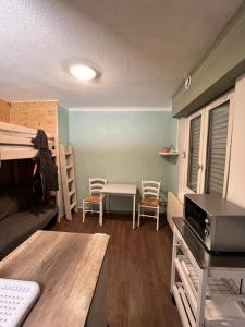 a small room with a table and a bunk bed at Studio centre-ville in Cluses +12 photos