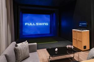 a living room with a tv with a couch and a table at Element Phoenix North Norterra in Phoenix