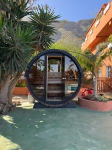 a round building with a mirror in a courtyard at Finca Rosa in Güimar +7 photos