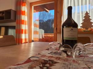 a bottle of wine sitting on top of a table at Apartments Insam in Santa Cristina in Val Gardena