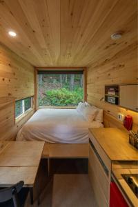 a bedroom in a log cabin with a bed at Postcard Cabins Western Catskills, Outdoor Collection by Marriott Bonvoy in Roscoe