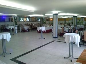 a dining room with tables and chairs with white tables at Hotel Castro in Santiago de Compostela