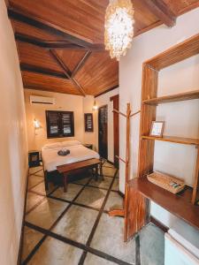 a bedroom with a bed and a table in a room at Vila Bela Vista in Jijoca de Jericoacoara