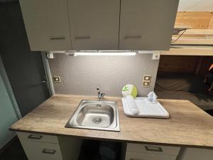 a kitchen counter with a sink and a keyboard at Studio centre-ville in Cluses